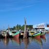 Perahu Kayu Bersandar di Muara Biru